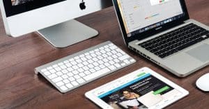 turned-on-imac-beside-macbook-on-table